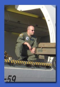 Loadmaster in action, unloading some cargo.